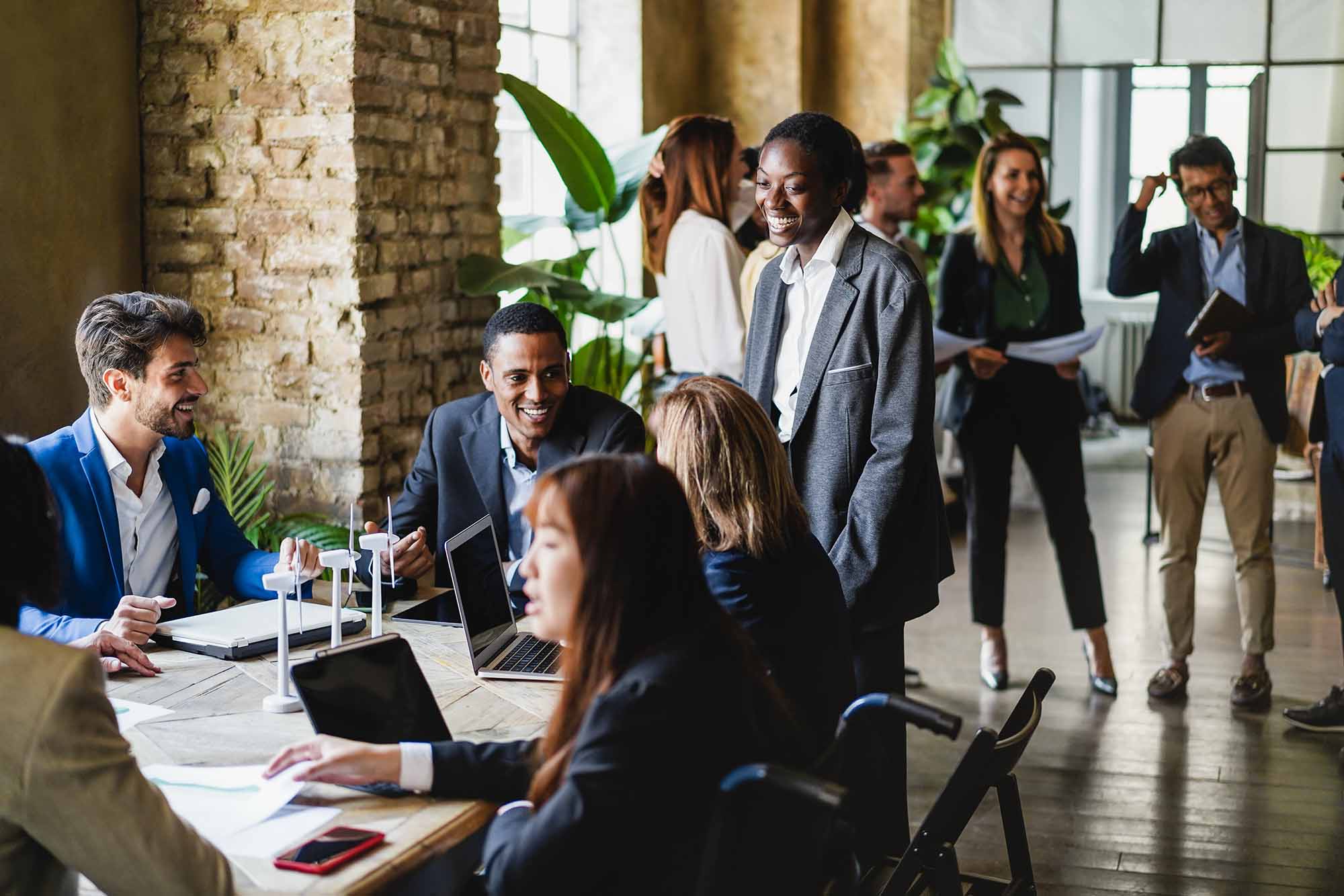is real estate a good career? Agents sitting around desk.